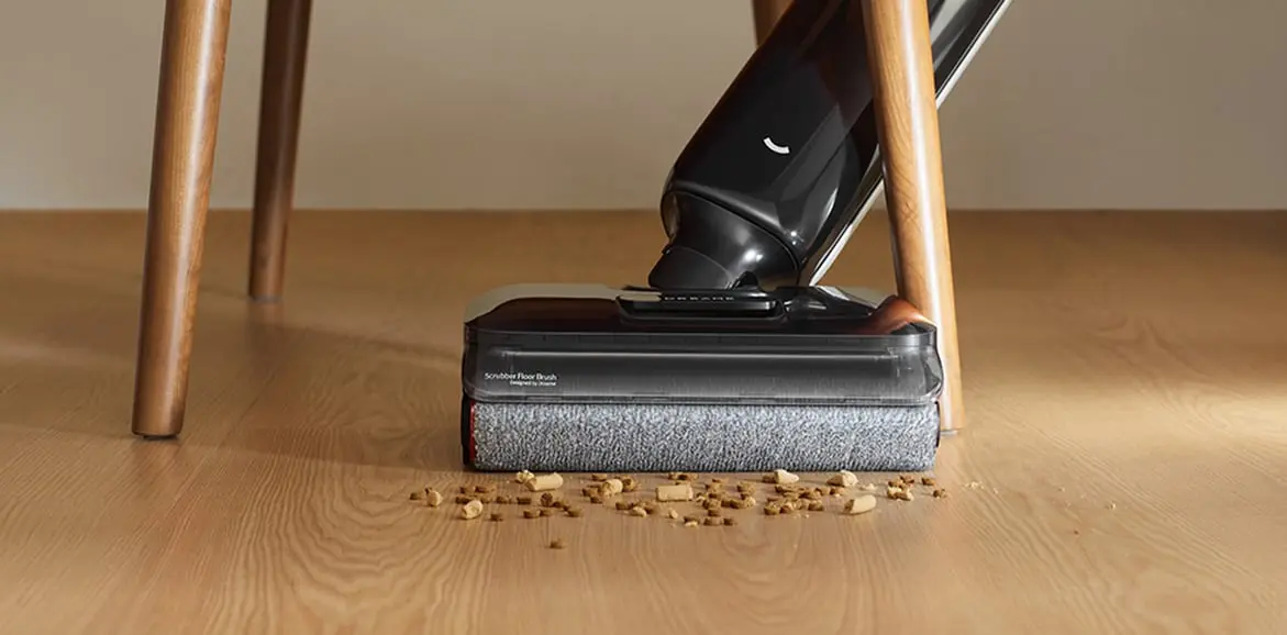 Dreame G12 Pro brush cleaning debris under a chair