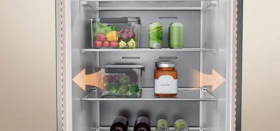 Interior of the refrigerator with vegetables, beverages, and arrows indicating shelf space