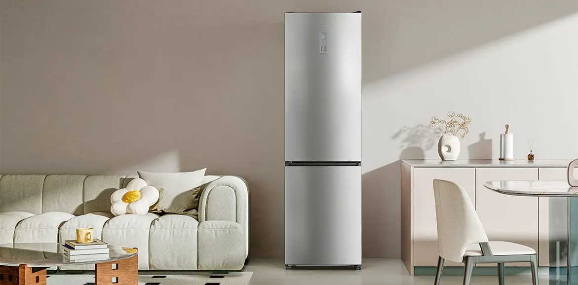 Silver Dreame refrigerator in a modern living room next to a sofa, table, and dresser
