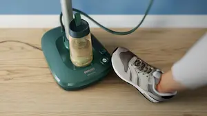 The base has foot buttons and a detachable water tank